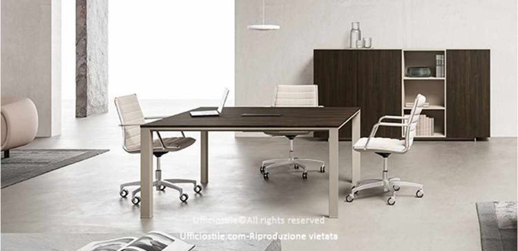 Tavolo riunioni quadrato Linea 471 da 140 x 140 cm con piano in MDF spessore 18 mm rivestito in melaminico, bordi perimetrali in ABS da 2 mm, top access integrato per la gestione dei cavi e madia coordinata con 3 ante e vani a giorno da 240 x 50 x 126,1 cm.